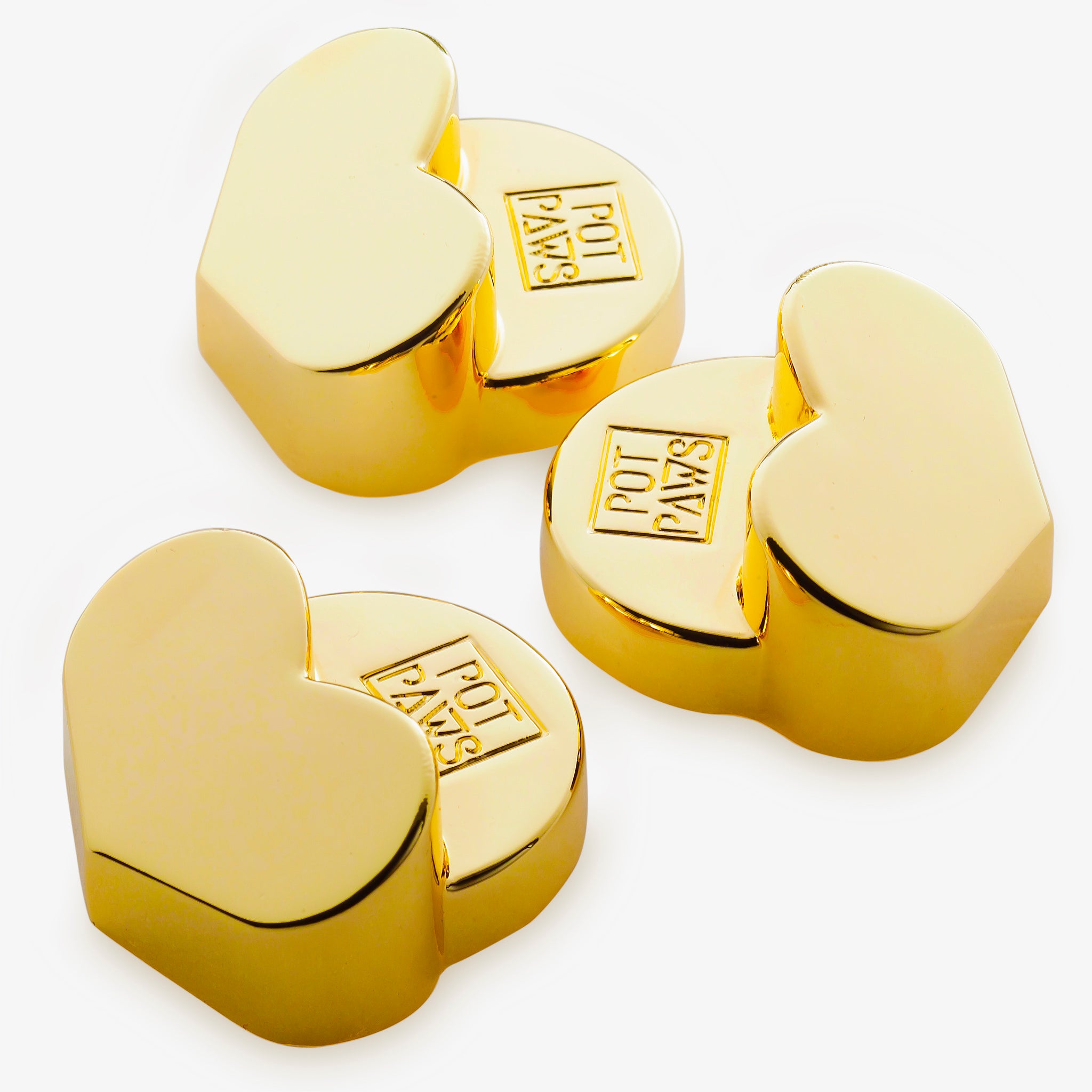 Gold heart-shaped pet bowl weights with engraved POT PAWS logo