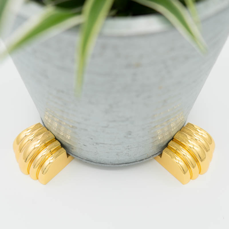 Plant pot elevated with golden POT PAWS pot feet