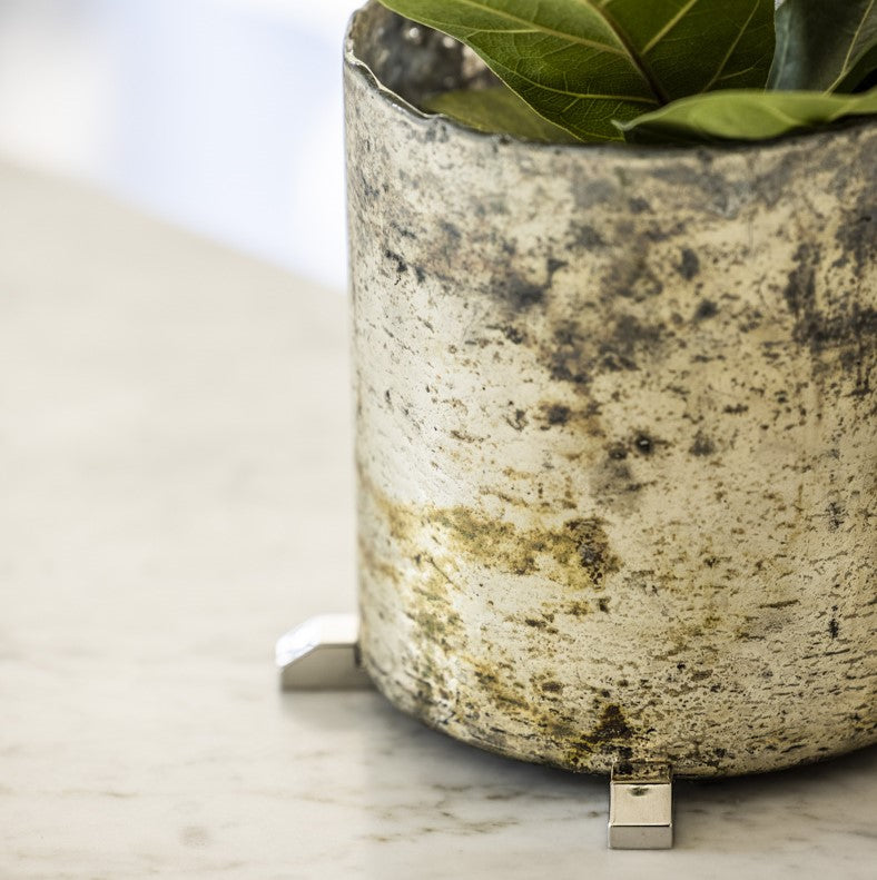 Silver heart-shaped POT PAWS feet lifting a glass planter to protect surfaces